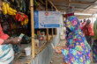 A woman receives WFP cash assistance for communities affected by monsoon floods in Bangladesh