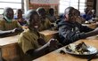 Donat enjoys a WFP-provided school meal.