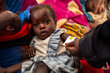 In the photo: Sittna (two years old) daughter of Magedah while getting her MUAC measurements taking by the nutrition officer at the WFP-Supported nutrition centre of Philippe in Portsudan.
