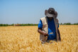 WFP Sudan staffer in a wheat field