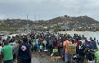 People gathered on a pier in the wake of a hurricane