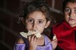 A little girl eating bread