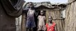 Nyaloth Duoth poses for a portrait with her children Dukan Kuony (C) and Nyamuch Kuoni (L) at her home in the Protection of Civilians (PoC) camp in Bentiu.
