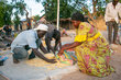 A woman buys food at a market with cash she received from WFP, thanks to EU funding.