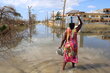 Photo: WFP/Alexis Masciarelli, a woman returns to her house carrying a box of WFP emergency food on her head, after a distribution in support of the emergency response of the government of Jamaica in the area of Arlington, St Elizabeth parish, one of the most damaged by Hurricane Melissa.