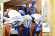 WFP warehouse workers unloading supplies in Haiti