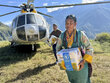 Photo: WFP/Tanya Birkbeck. WFP delivers food by helicopter to residents of Thuman village, Rasuwa district, Nepal, after floods destroyed the road connecting the community to surrounding areas.