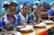 Photo: WFP/Alexis Masciarelli. students aged 5 to 7 eat a hot meal in their classroom in the primary school Baptiste Salem in Dondon, where 600 children are registered. Meals are preparing daily with rice and beans food purchased from local producers through WFP Home-Grown School Feeding programme. 