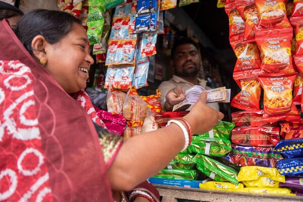 A local resident in Moulvibazar withdraws cash assistance provided by WFP through its anticipatory action programme.