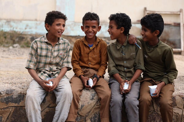 Photo: WFP/Hussam Al-Qalaa. Schoolchildren hold high-energy biscuits from WFP.