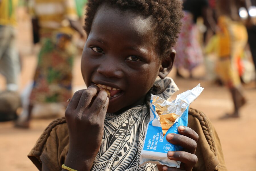 A child eating WFP high-energy biscuits