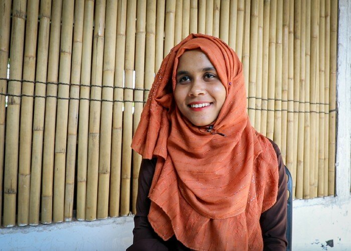 a woman is smiling to the camera