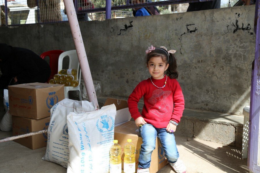 A girl with her family's food tations WFP/Hussam Alsaleh
