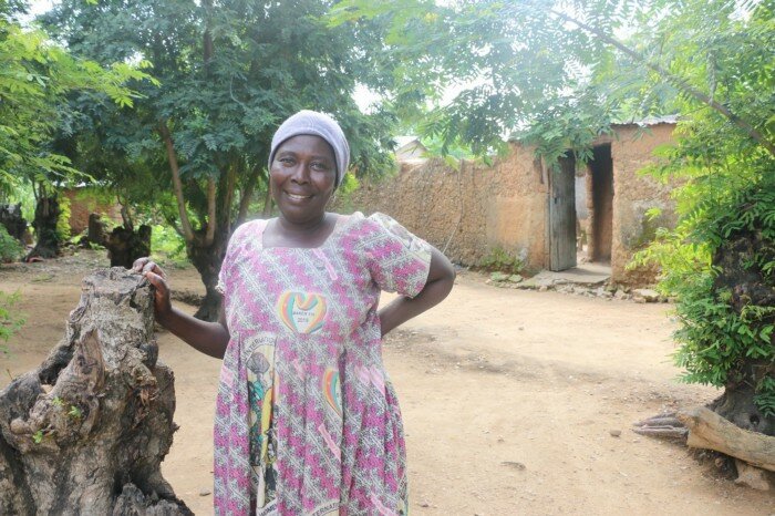 a woman is smiling at the camera