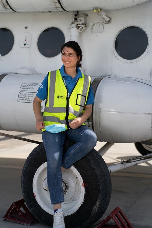 a woman in front of an airplane