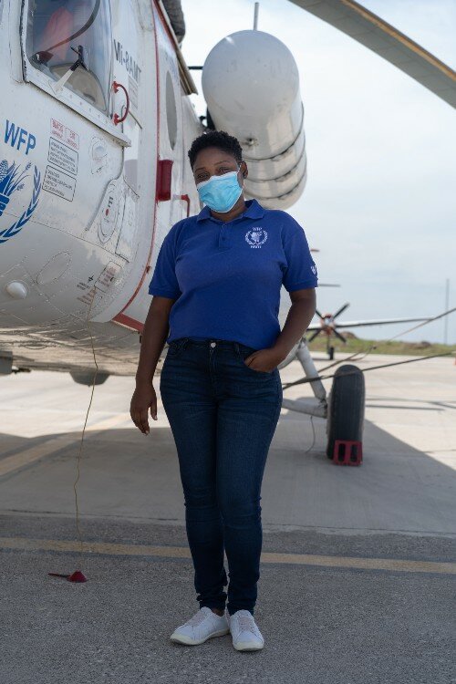 a woman in front of an airplane