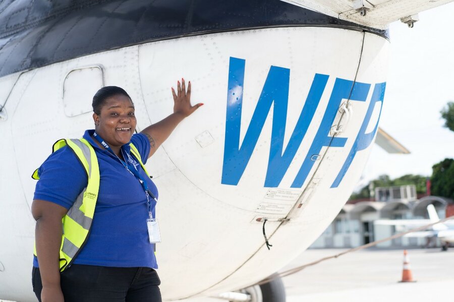 a woman in front of an airplane