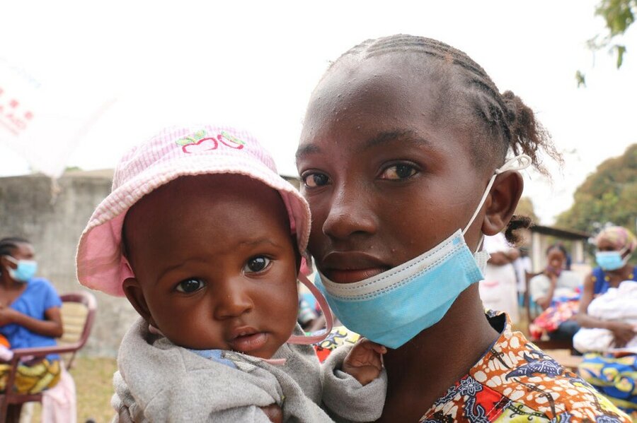 a woman is holding her baby