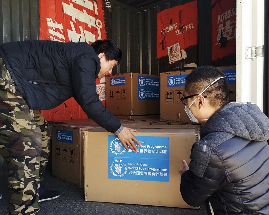 two man are carrying boxes