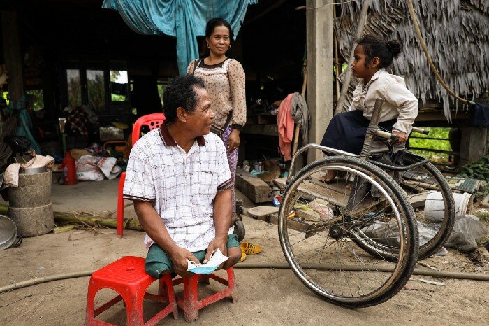 a disabled man with his family