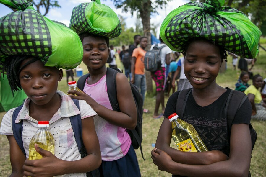 Schoolgirls in Beira, Mozambique, taking home rations before schools closed in April. Photo: Karel Prinsloo/Arete/UN Mozambique