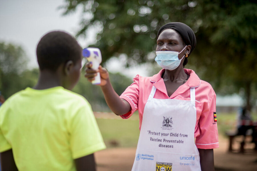 A volunteer from the Ugandan Red Cross at Napumpum school in Kotido in July—one of 311 targeted with take-home rations after coronavirus restrictions resulted in closures. 