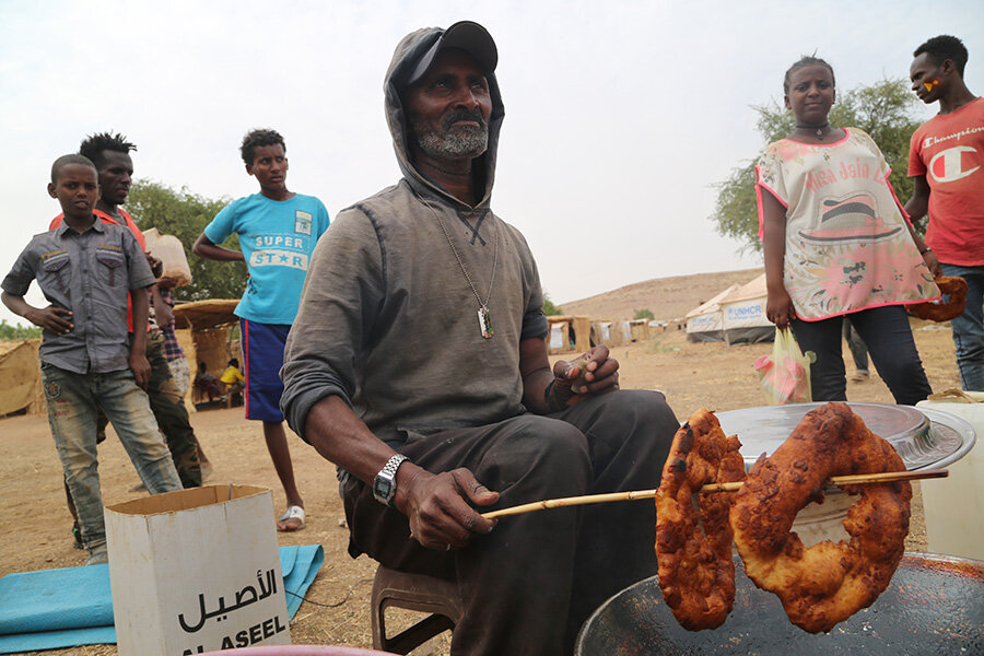 A man makes an Ethiopian pastry known as Bombolino