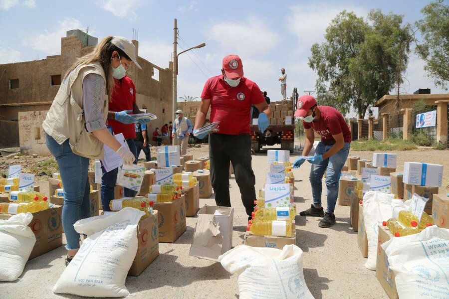 Rania at a WFP distribution site making sure everything is in order before people arrive to receive their monthly assistance. WFP is providing monthly food rations for nearly 5 million people across Syria. Photo: WFP/Hussam Al-Saleh