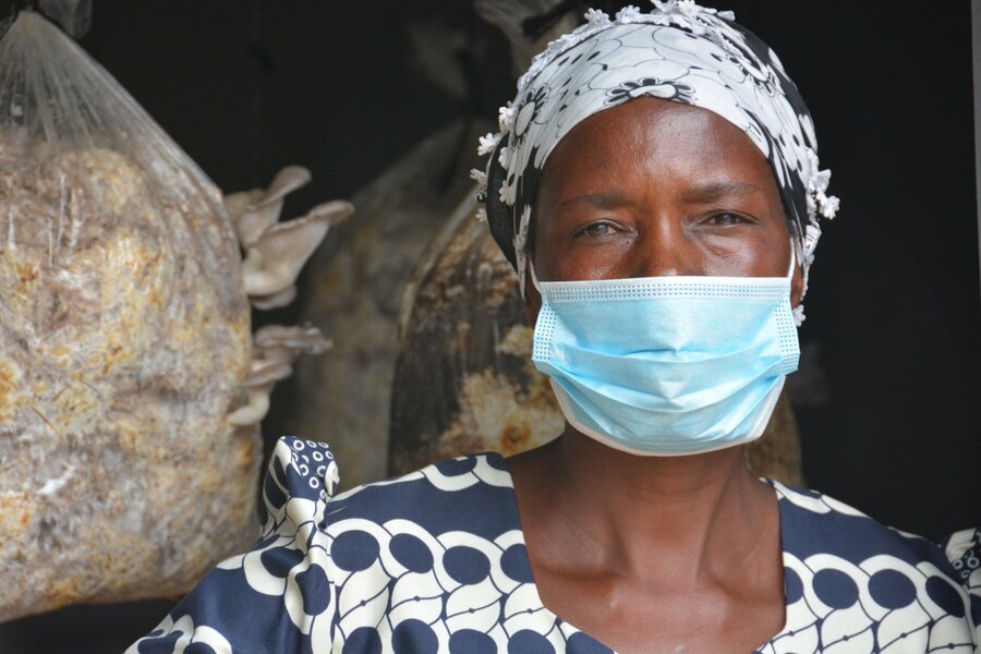 woman stands inside her mushroom hub at home