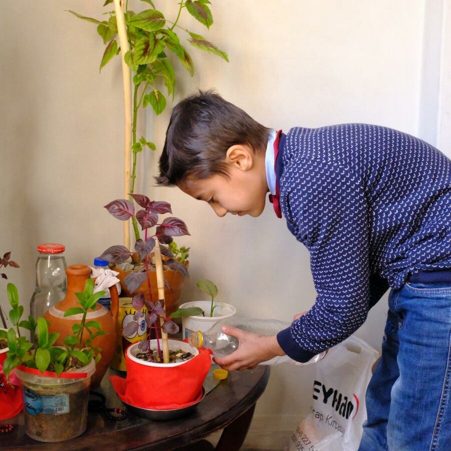 Abdulrafea watering a plant