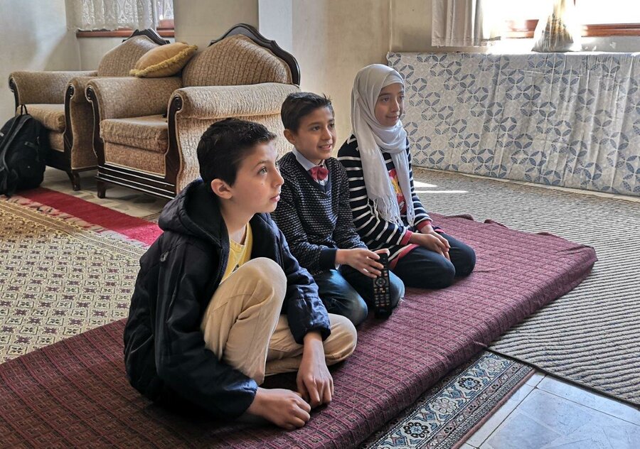 In his free time, Abdulrafea enjoys reading books, watching television and playing with his sister (right) and cousin (left). His cousin lost both his parents before what remained of the family fled to Turkey. Photo: WFP/Mehmet Cemtaş