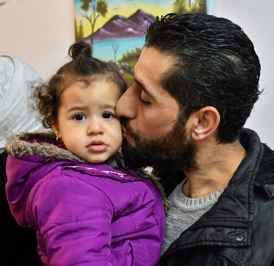 Shady's father Khales plants a kiss on his youngest daughter's cheeks