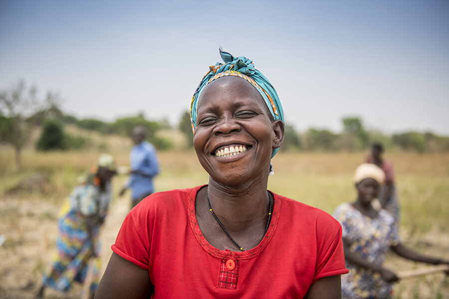 Aisha Apia, a member of the Jujumbu farmer group laughs as she cultivate land they have acquired from host communities in the Lobule refugee settlement in northwest Uganda. Photo: WFP/ Hugh Rutherford