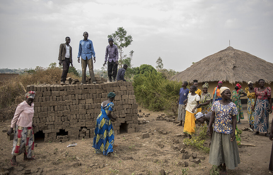 The Jujumbu farmers group work on constructing a new warehouse to store their grains in the Lobule refugee settlement in northwest Uganda. Photo: WFP/Hugh Rutherford