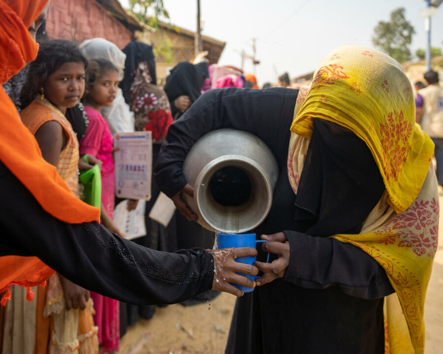 Volunteer pours water