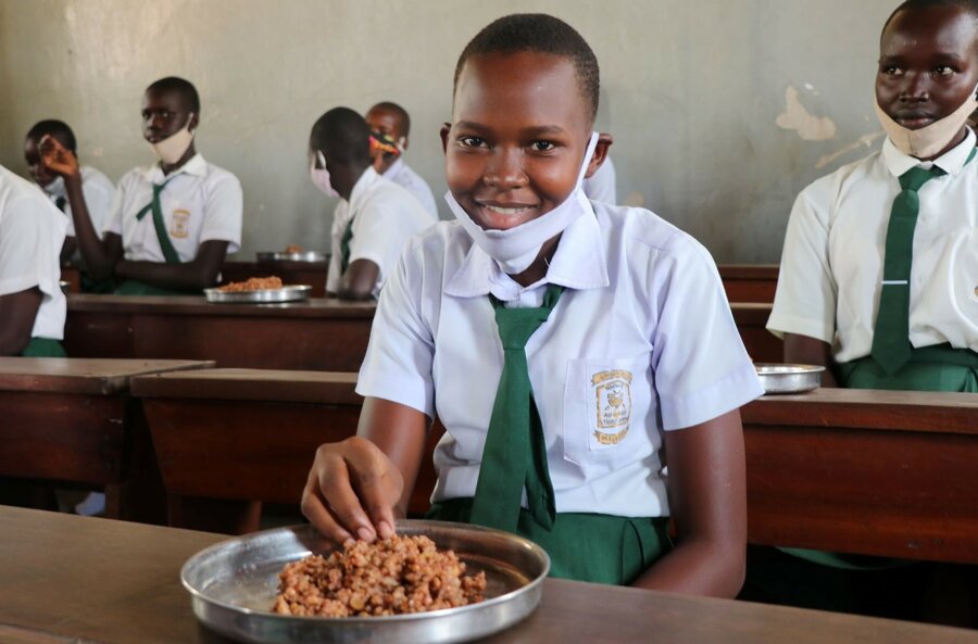 A pupil of Mayo girls primary school enjoys a school meal provided by WFP. Photo/WFP