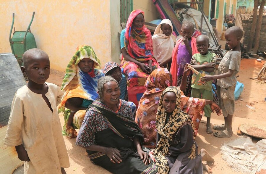 Women and children who were displaced by clashes in West Darfur gather out in the open to discuss community issues. More than 100,000 people are displaced inside of Geneina and are staying at 90 places within the city.