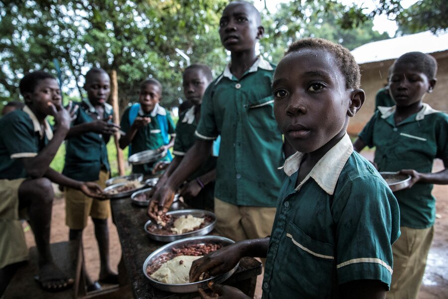 School boys enjoy a hot meal of posho and beans at their school in Yambio.