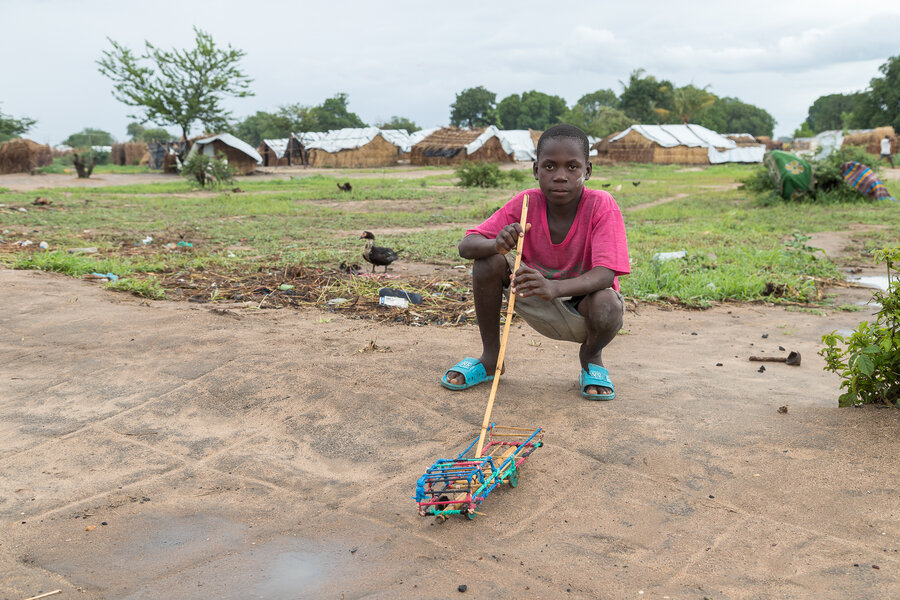 A boy in 25 de Junho shows off a toy he’s made 