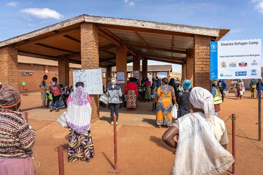 People line up outside the Dzaleka Refugee Camp.