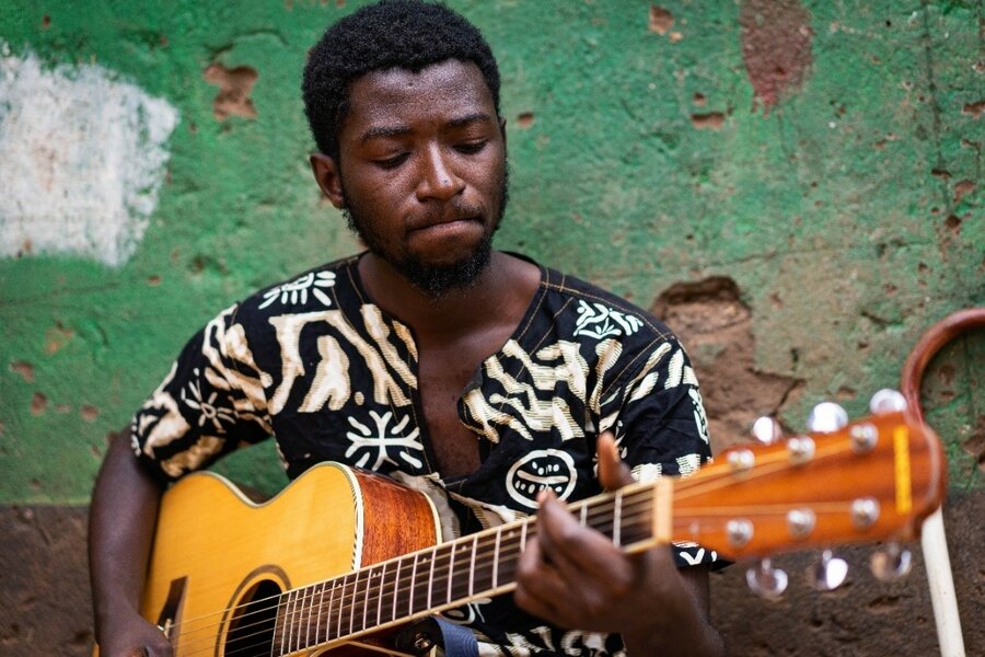 A man playing a guitar.