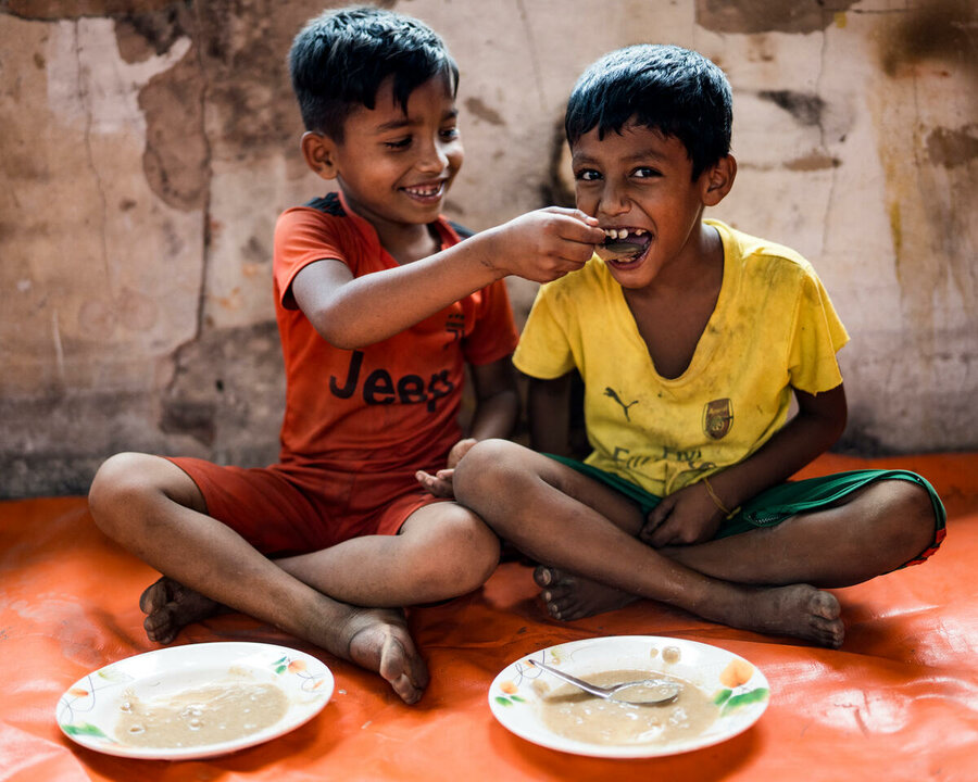 two children are eating their meals