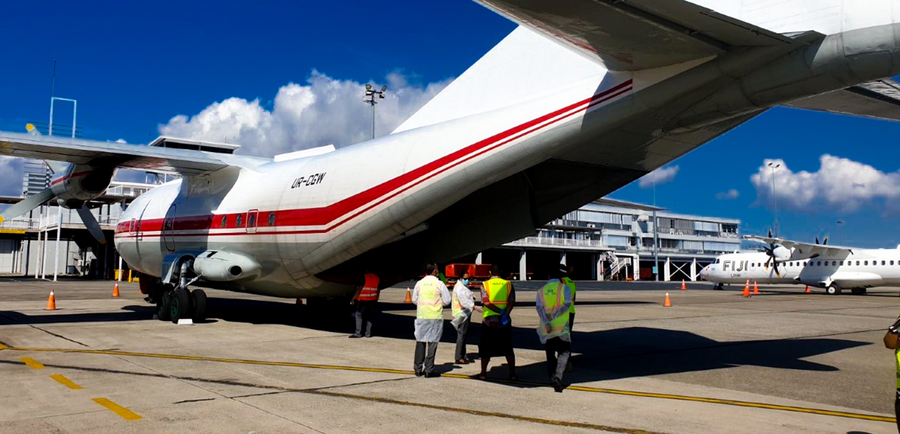 People seeing cargo unloading from plane