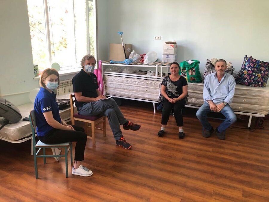 Raisa and her husband pictured with two WFP staff 