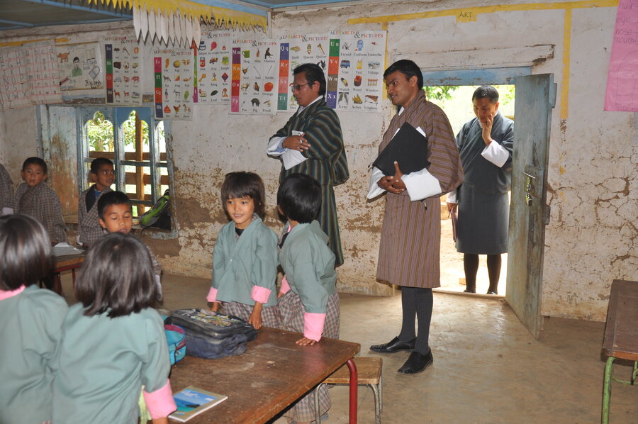 Adult and children in a school