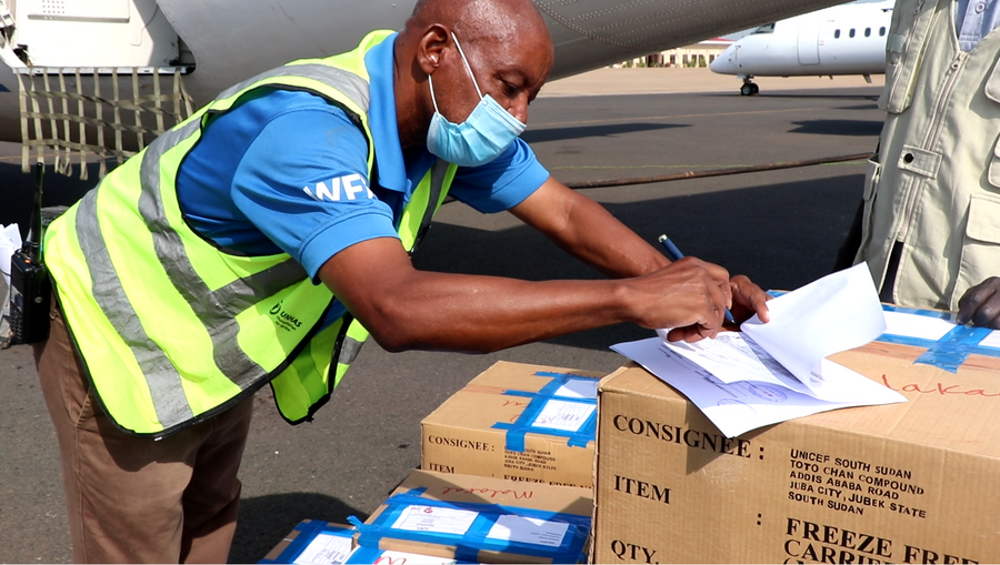 An UNHAS staff member finalizes boarding documents for vaccines destined for Malakal in the north of the country. Photo: WFP