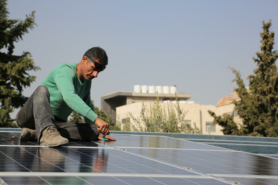 man installing solar panel