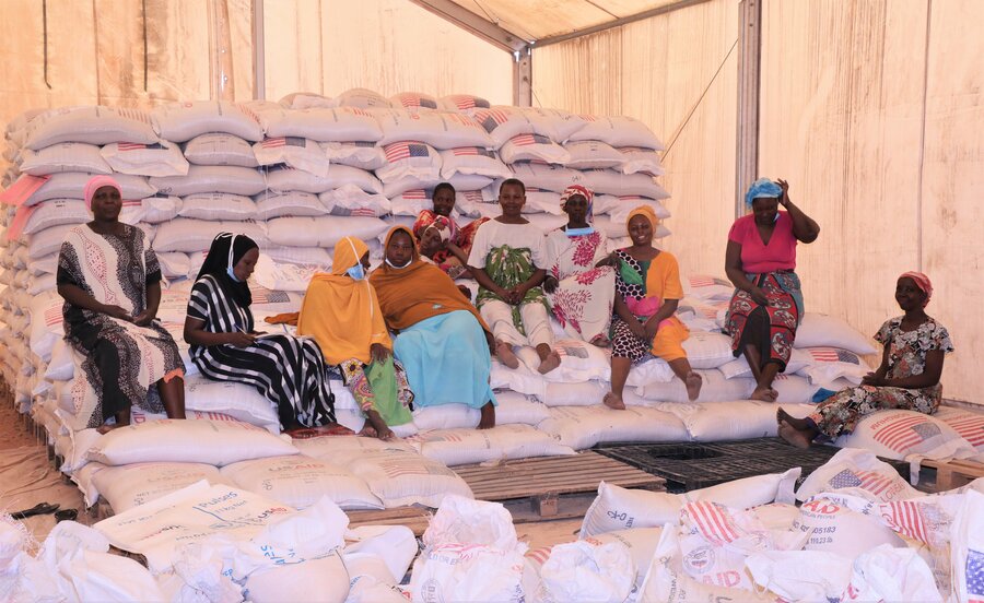 8.	Mwanahamisi and other women carry and pile repackaged commodities in readiness for distribution