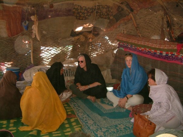 veiled women sitting in a circle in a tent