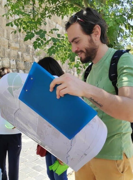 Man stood up and reading a map outdoors